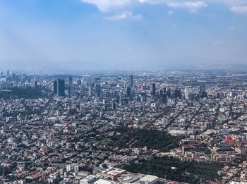 High angle view of illuminated city buildings against sky