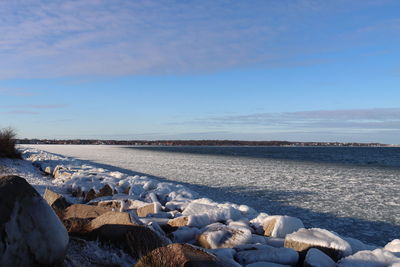 Scenic view of frozen sea against blue sky