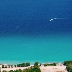 High angle view of sea against blue sky