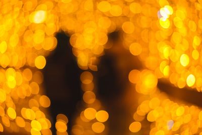 Defocused image of illuminated christmas lights at night