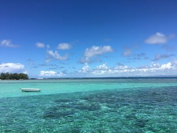 Scenic view of sea against blue sky