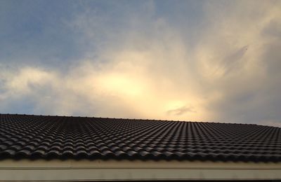 Low angle view of building roof against sky