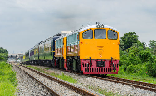 Train on railroad track against sky