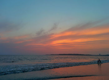 Scenic view of beach against sky during sunset