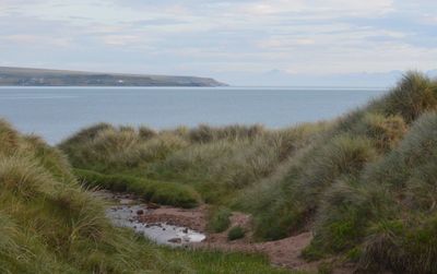 View of calm sea against cloudy sky