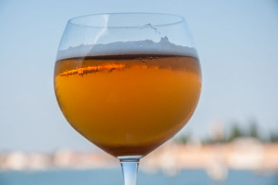 Close-up of beer against sky