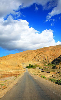 Empty road with mountain in background