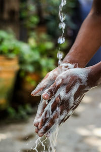 Close-up of hand pouring water