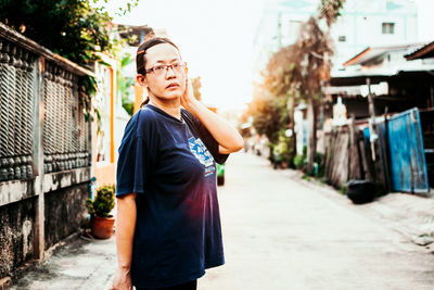 Portrait of young woman standing outdoors