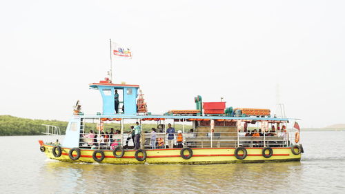 Boats in sea against clear sky