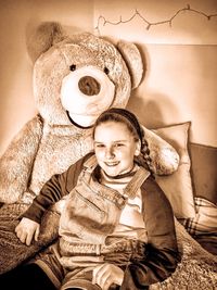 Portrait of smiling boy sitting on sofa