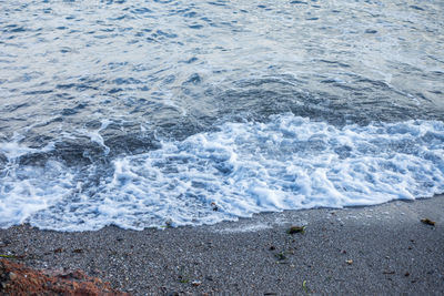 High angle view of waves rushing towards shore