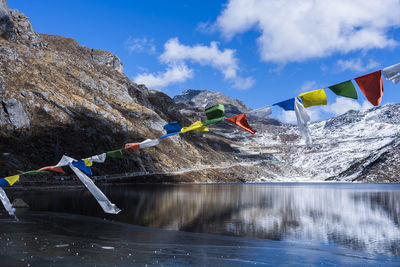 Traditional flags over the lake against sky