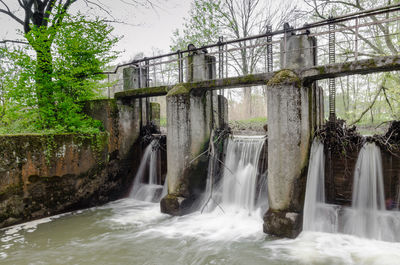 Scenic view of waterfall against sky