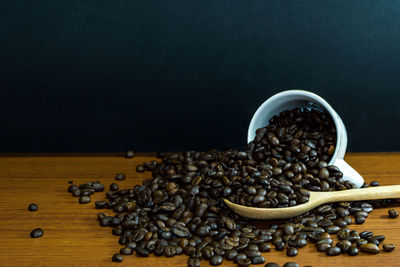 Close-up of roasted coffee beans on table