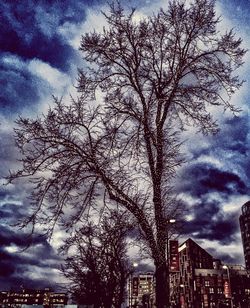 Low angle view of buildings against cloudy sky