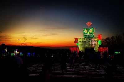 Illuminated building against sky at night