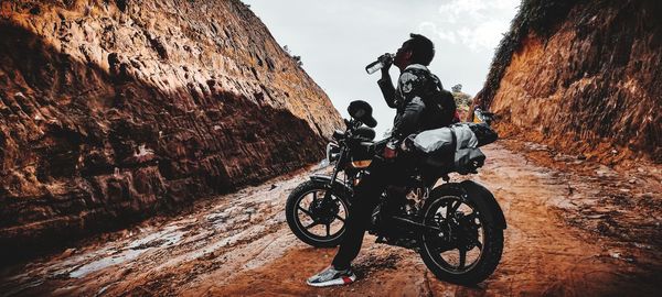 Man riding bicycle on cart