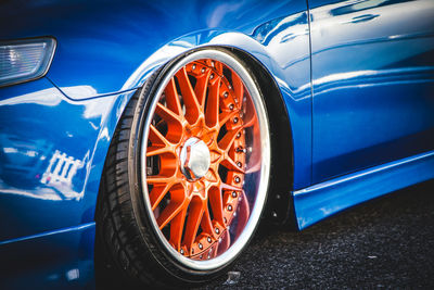 Close-up of blue car on road