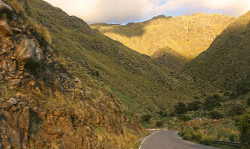 Road amidst mountains against sky