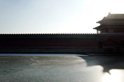 Temple by road against clear sky