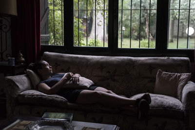 Woman relaxing on sofa at home