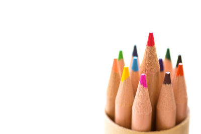 Close-up of colored pencils against white background