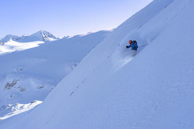 People on snowcapped mountain