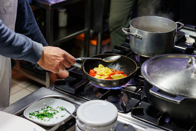 Midsection of man preparing food in kitchen