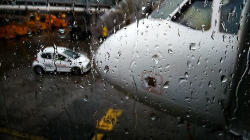 Airplane seen through wet car window