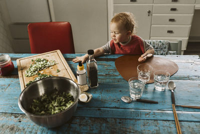 Girl sitting at dining table at home