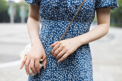 Midsection of woman standing against blurred background