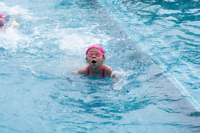 Portrait of boy swimming in pool