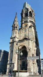 Low angle view of bell tower against blue sky