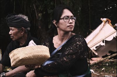 Portrait of balinese woman sitting outdoors 