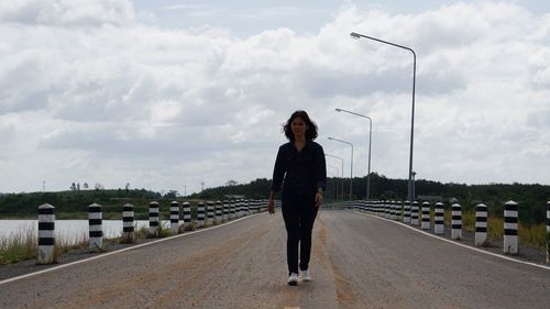 Man standing on road against sky