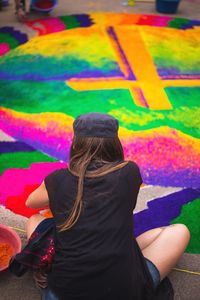 Rear view of woman standing against multi colored