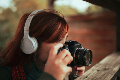 Portrait of woman photographing