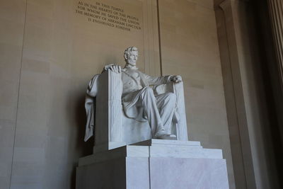 Low angle view of statue against temple