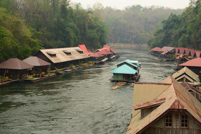 Scenic view of river amidst trees and buildings