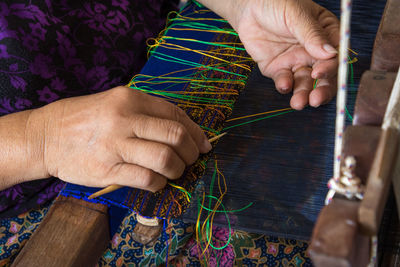 Midsection of woman weaving