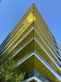 Low angle view of modern building against clear blue sky