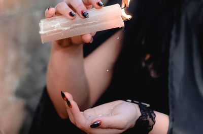 Midsection of woman holding hands