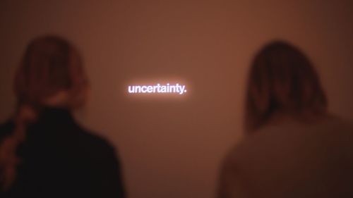 Rear view of woman with text on wall