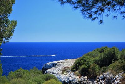 Scenic view of sea against clear blue sky