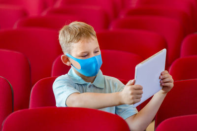 Rear view of boy sitting on seat