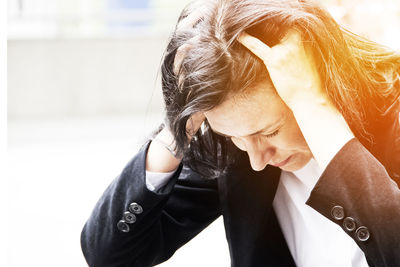 Stressed businesswoman with hands in hair