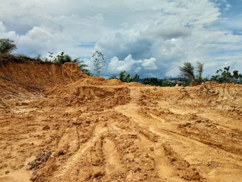 Scenic view of arid landscape against sky