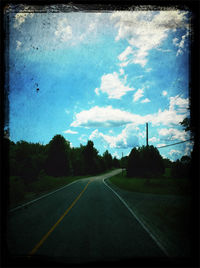 Empty road along trees