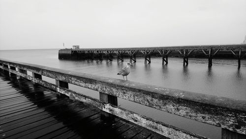 Pier over sea against clear sky